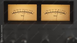 Audio signal levels monitoring audio console on classic sound amplifier. Close-up analog signal indicator with arrow