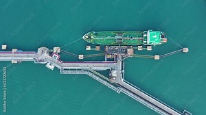Arial top view of Oil,Chemical tanker ship loading and uploading oil and lpg,NGV gas at industrial estate over open sea at seaport Thailand. Oversea transportation,Import-Export Business and Logistic.