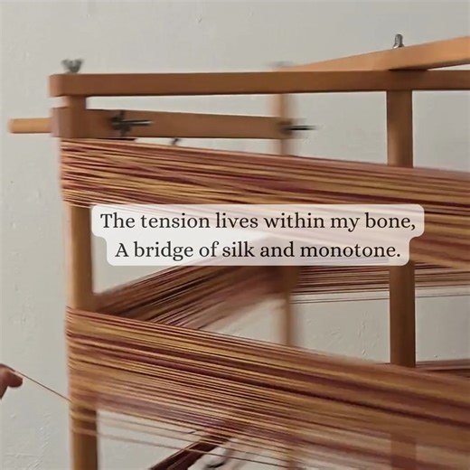 Thoughts on what warping means to me. There’s a beautiful technicality to winding a warp. Naturally a rhythm is set, your body becoming part of the process. It’s a perfect example of "flow state"—where the repetitive motion acts as a mantra. The Measured Path "Between my thumb and pointer’s crook, The fiber writes a silent book. A figure-eight, a steady pull, The air grows thin, the hand grows full. Each circuit is a minute shed, A world distilled to single thread. I wind the warp, I count the t