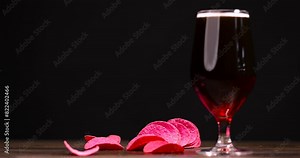 dark beer in a glass glass, fresh dark alcoholic beer on the table on a black background