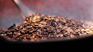 Roast coffee beans before blending or grinding them to make fresh coffee with traditional methode using a clay stove