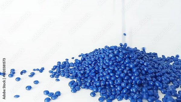 blue masterbatch granules fall like raindrops from above, forming mounds and layers of masterbatch, isolated on white background, for plastic industry product profile video