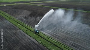 Aerial view of Crop Irrigation using the center pivot sprinkler system. An irrigation pivot watering agricultural land. Irrigation system watering farm land.