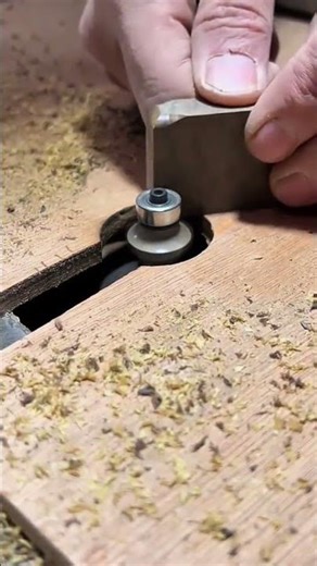 Precision Routing: Woodworker Shaping a Small Wooden Block with a Router Table