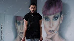 Happy man dancing in modern class. Cheerful guy performing hip hop steps indoors