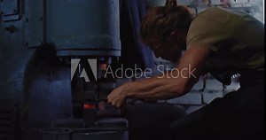 master is processing metal workpiece by automatic forging hammer in workshop, 4K, Prores