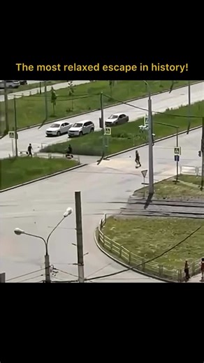 Quickory on Instagram: "The post features a 50-second viral clip captioned “The most relaxed escape ever,” capturing a surreal, low-speed pursuit filmed from a high-rise window. The footage shows a police cruiser slowly trailing an individual on an electric scooter, who appears completely unbothered by the law enforcement presence behind him. Videos like this go viral because they subvert the Hollywood trope of the “high-speed chase.” The comedy arises from the sheer lack of urgency; the contras