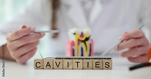 Dentist studies treatment of the oral cavity and problem of cavity. Tooth decay and infectious diseases associated with microbes