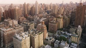 Epic aerial with cinematic Upper East side panorama. Prestige luxury real estate properties and business offices in skyscrapers on Manhattan. Scenic New York City views in warm sepia colors background