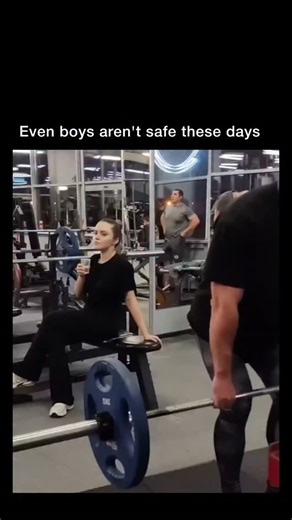 Dark Vids on Instagram: "This post shows a 13-second gym clip where a woman on a bench drinks from a cup while locked into a completely shameless stare at a guy deadlifting in front of her—eyes wide, lips biting, head tilting, and full “I am absolutely not hiding this” energy as he bends over to grip the barbell. It taps into the viral trend of role-reversal gym reels, where the usual “creep caught staring” dynamic gets flipped, turning a basic lift into a comedy scene built entirely on her esca