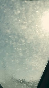 Window washer on the street corner, Man cleaning car windows with enthusiasm, Street window cleaning service, Car window cleaner with a smile, Man washing car windows for a living, Street scene with