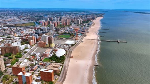 Descend over the wide sandy beach in Coney Island, New York, USA.