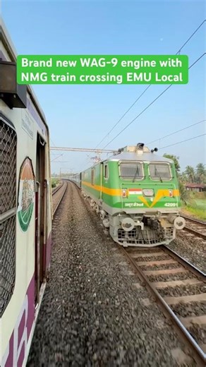 Brand new WAG-9 engine with NMG train crossing EMU Local