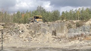 Mining industry. View into a quarry mine for porphyry rocks. factory. Quarry and mining equipment. Large multi-toned mining truck in a limestone quarry. Quarry equipment. Mining industry.