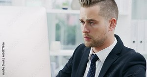 Business man, reading on computer and working in office for online research, financial report or proposal review. Professional worker or corporate employee on desktop for website or email management