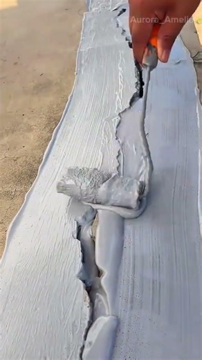 painting gray waterproof coating using a paint roller tool for a professional building project