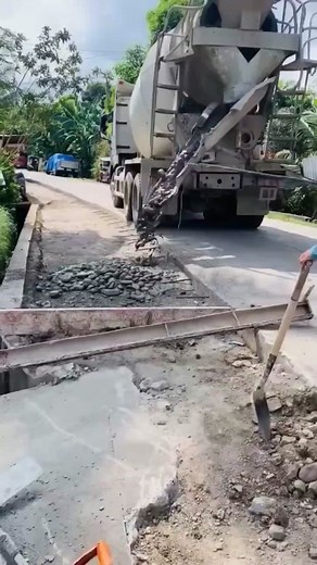 Cement Mixer Truck Pouring Fresh Cement on Road