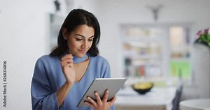 4K Beautiful woman using computer tablet at home & smiling. Slow motion Stock Video