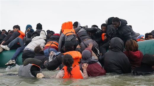 Migrants attempt to board small boat