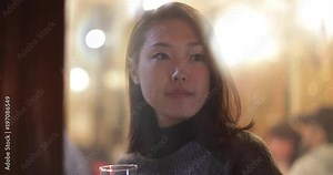 Japanese woman in restaurant looking out of window. Tokyo, Japan