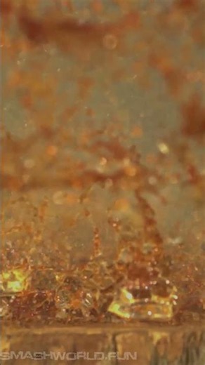 Bullet hits glass skull bottle shatter slow motion