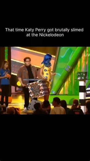 celebrityclipzone on Instagram: "One of the craziest moments in Nickelodeon history happened at the 2010 Kids’ Choice Awards when Katy Perry was “assassinated” by slime. As she opened a box to present an award, the slime didn’t just pour—it blasted her with the force of a fire hose! The pressure was so intense it literally knocked her off her feet and sent her sprawling across the stage. Fans often joke it was a “hit job” because of how brutal it looked compared to other celebs. Katy later admit