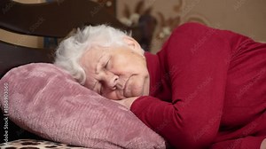 Mature old woman resting alone sleeping well in comfortable bed lying asleep on soft pillow relax on orthopedic mattress enjoy good night sleep. Mature person home routine in retirement