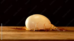 The egg fell and broke. A broken egg is picked up and raised.