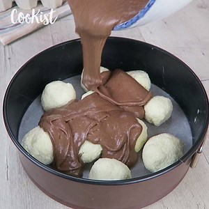 She makes balls using coconut and then she pours cake batter over them. The result is unbelievable!