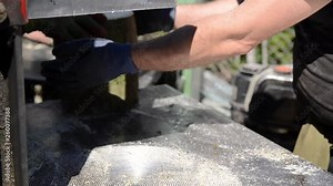 Man works with Wood Chopping Machine. Worker splitting wood to firewood for the winter, close up. Saw cutting wood. Log splitter splitting firewood. Log Cutting Saw Machine. Woodchopping.Wood industry