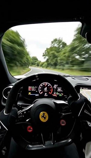 POV driving a modern sports car on a curving countryside road.