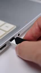 Inserting a usb drive into a laptop computer.