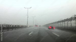 Rain is a hurricane storm while driving a car on the highway. A dangerous tornado caught transport drivers on the way.