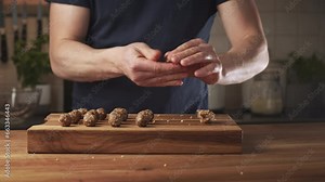 A man making date and walnut sweets at home. Cleaning and chopping dates.