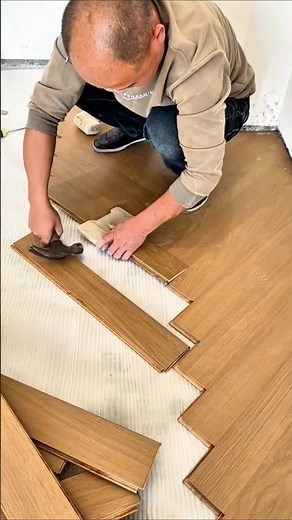 Installation Process of Click System Wood Flooring with a Hammer