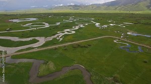 River system winding through green landscape valley in Afton Wyoming.