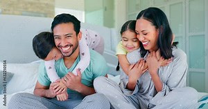 Surprise, morning and hug with family in bedroom for playful, happy and wake up. Smile, happiness and support with portrait of parents and children in bed at home for love, care and bonding