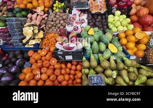 Vibrant fruit market with colorful tropical fruits mangoes, oranges, pears, and berries. Fresh organic produce