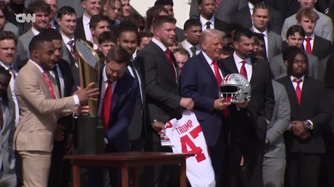 Vance drops college football championship trophy