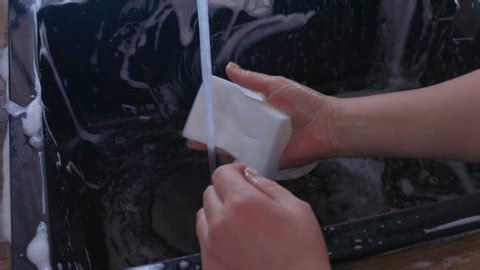 clip-4010684635-side-view-female-hands-washing-black-sink