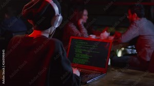 Rare view of young woman sitting at computer in bar and developing new computer program