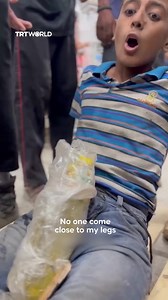 A Palestinian boy was shot in the leg by Israeli forces while retrieving aid in besieged Gaza on August 18. He arrived at al-Shifa Hospital still clutching the bottle of cooking oil he had managed to collect. | TRT World
