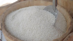 Baskets filled with White Rice accompanied by a Metal Scoop, ideal for various Culinary Uses