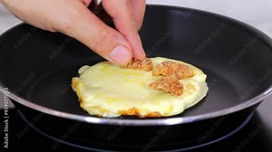 Making an arepa or taco with melted mozzarella cheese and pan fried pork rinds.
