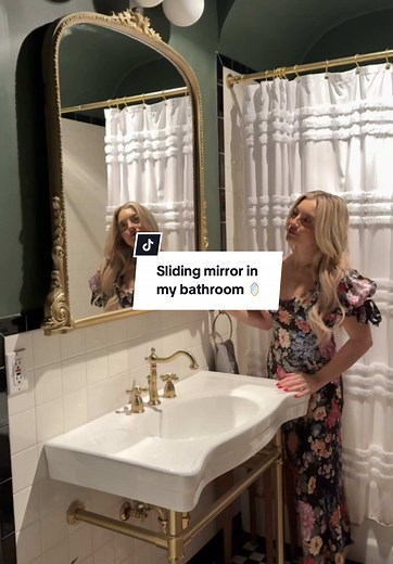 sliding vanity mirror in our bathroom 🪞 I wanted to use an oversized French style mirror in our bathroom without loosing the storage from the recessed medicine cabinet that was already installed. First we removed the cabinet and surround and measured the mirror and the lights to make sure it would fit. In order to make the mirror able to slide, we added a custom cut piece of plywood to the back of the mirror with liquid nails and painted it gold to match. Then to the wall we added two strips of