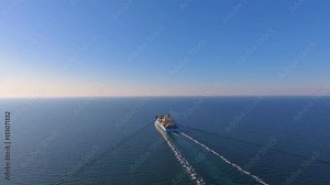 Aerial view of container ship floats in the open ocean after loading in the port of China at full speed. 4K.