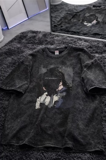 This oversized, acid-wash charcoal t-shirt features a gritty, cinematic graphic of two figures with the phrase