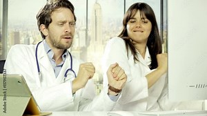 Two doctors dancing happy in hospital office 4K