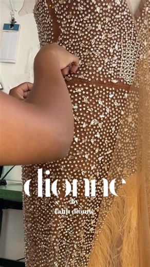 Dionne’s hand-beaded gown Encrusted champagne crystals glisten over brown mesh, blending seamlessly with brown skin tones. A sculpted corset hugs every curve, while a high split lined with hand-dyed ostrich feathers catches the light with every step. Custom made for this special bride. Stay posted for the final photos soon. | The Dionne