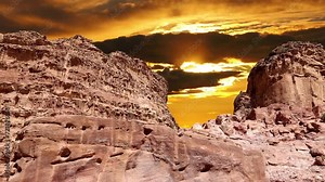 Mountains of Petra (against the background of the sunset, 4K, time lapse), Jordan, Middle East. Petra has been a UNESCO World Heritage Site since 1985